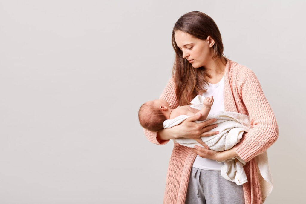 beautiful-dark-haired-mother-with-newborn-baby-hands-1024x683.jpg