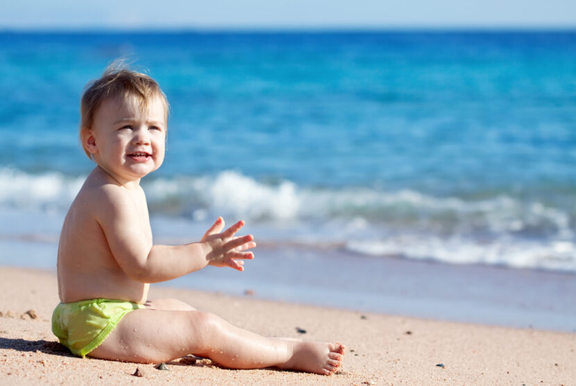 happy-toddler-sand-beach-830x557.jpg