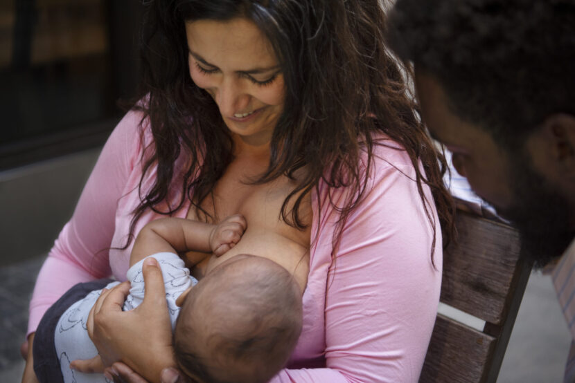 high-angle-smiley-mother-breastfeeding-830x554.jpg